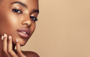 Close up portrait of young, beautiful model with with vibrant, melanin-rich skin tone.